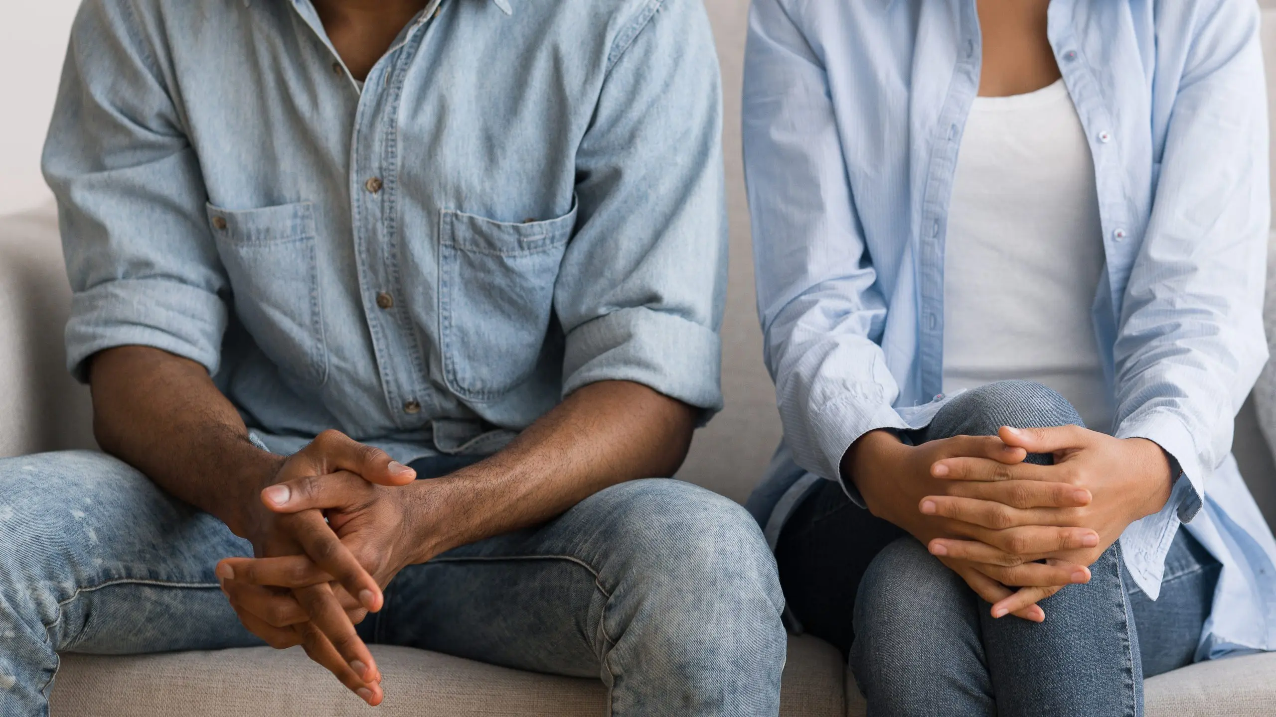 Couple sitting on a couch at a marital counselor's office