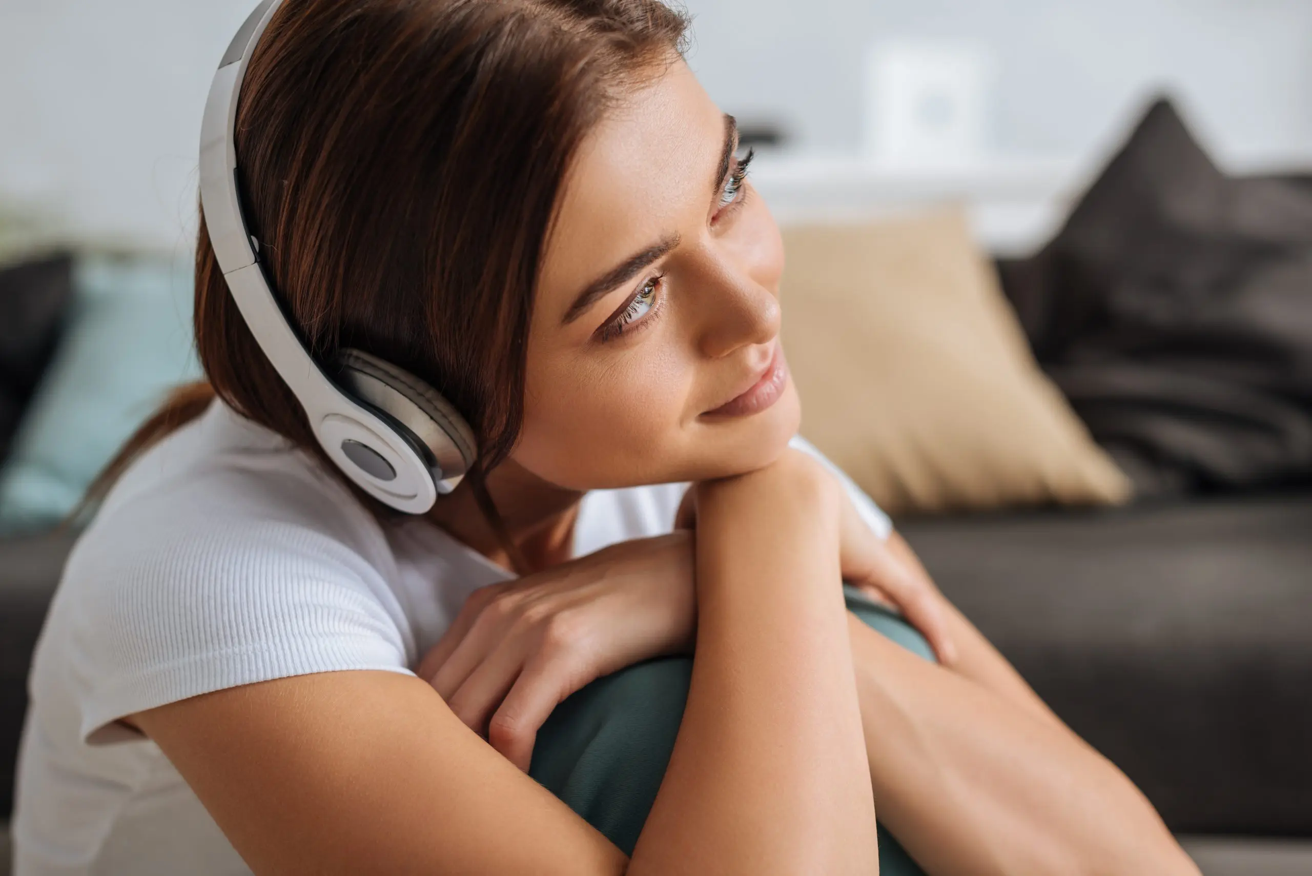 Girl listening to music with headphones at home