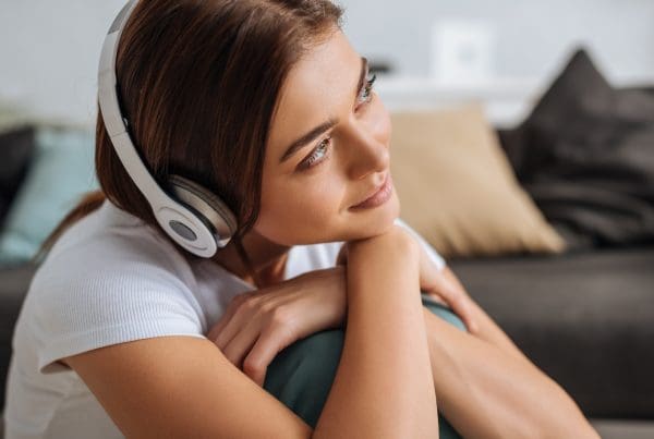 Girl listening to music with headphones at home