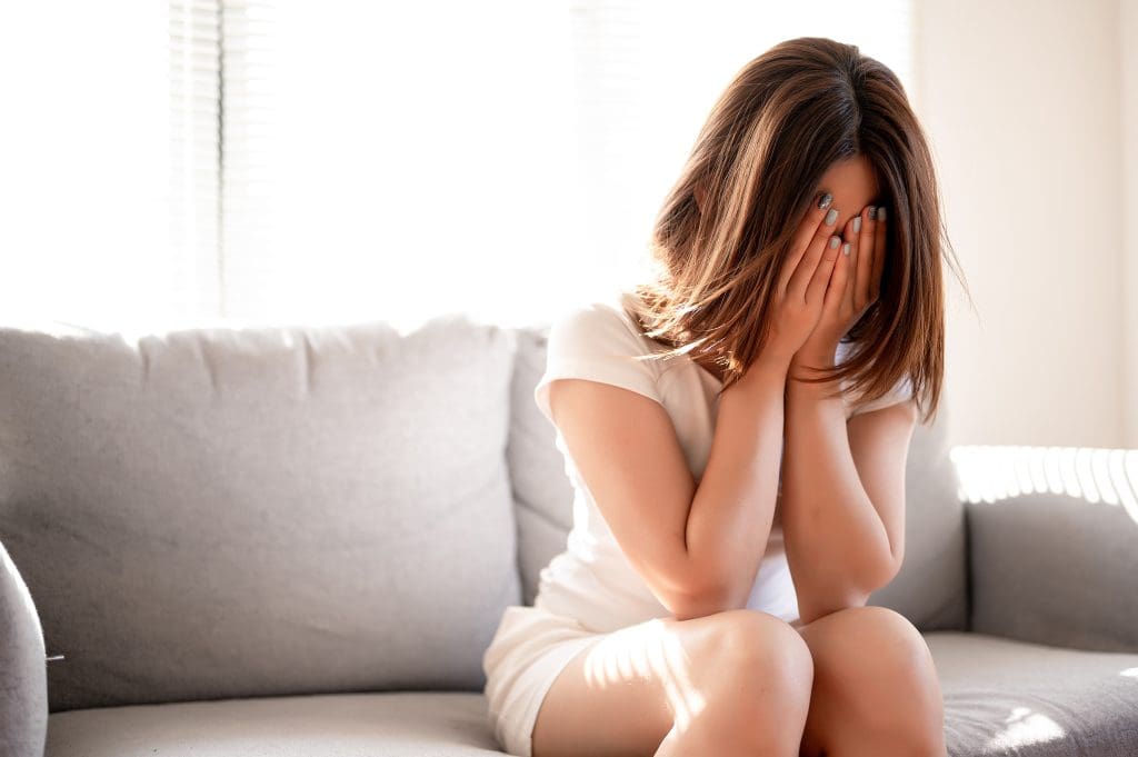 Woman holding her face crying