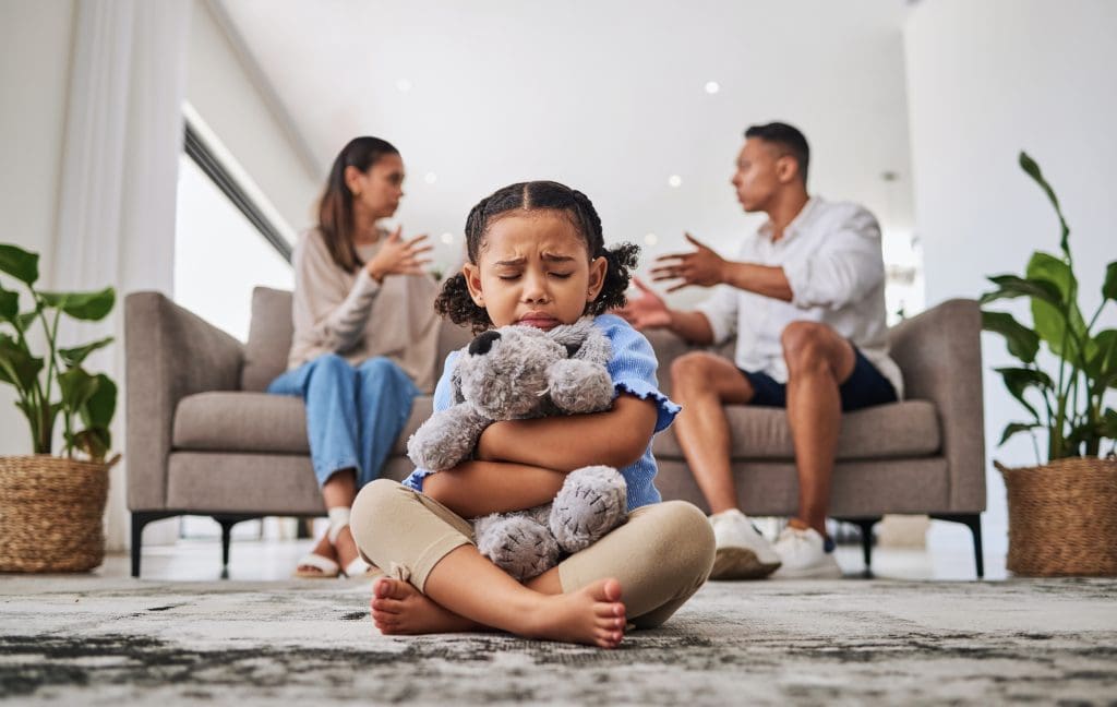 Parents fighting in front of sad girl in living room